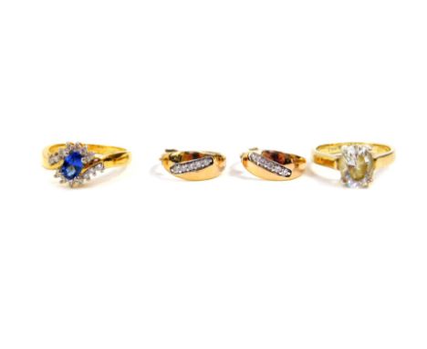 A Tru diamonds dress ring, set in yellow metal, with sapphire and white stones, in a crossover design, size M, 3.0g., a pair 