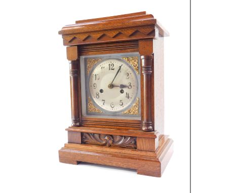 A late Victorian oak cased mantle clock, silver dial, with brass scroll spandrels, bearing Arabic numerals, eight day movemen