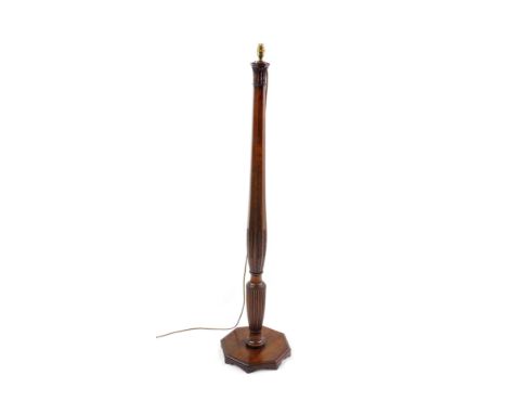 A Hepplewhite style early 20thC mahogany and line inlaid standard lamp, of octagonal and fluted form, carved with leaves and 