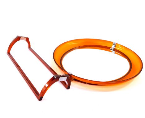 A vintage 1970's orange fibreglass oval wall mirror, 43.5cm high, 50cm wide., together with an orange fibreglass wall mounted