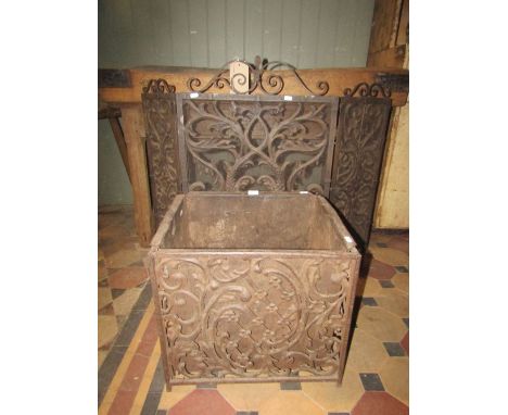 An Arts &amp; Crafts iron work folding firescreen, the framework with geometric detail and scrollwork pediment enclosing wire