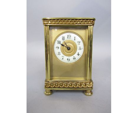 Interesting brass carriage clock with gilt face and enamel chapter ring, with applied chain link decoration to borders