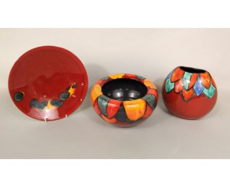 A collection of Poole pottery red ground wares with coloured abstract decoration comprising a bowl with curved rim, 23cm diam