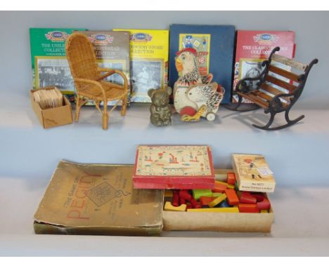 A box containing a collection of various vintage toys to include a pull along chicken and various dolls furniture