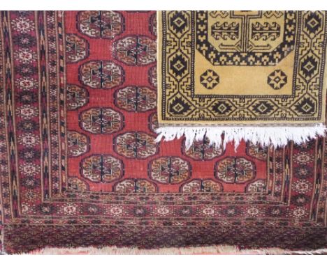 A Persian red ground rug, multi medallion centre within wide repeating geometric borders, 120 x 150cm, together with a furthe