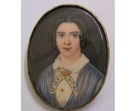 A 19th century portrait miniature of oval form bust length study of a young woman in blue dress with white lace collar, in an