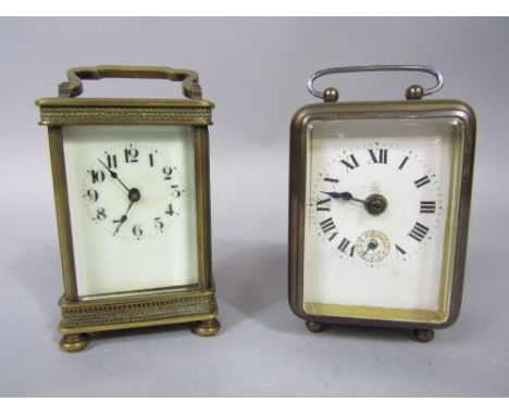 Early 20th century brass carriage clock with pierced geometric rim, together with a further wind up carriage type piece (2)