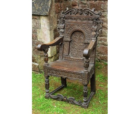 A good 17th century oak Wainscott chair, the panelled back enclosing a recessed arched panel showing the tree of life, within