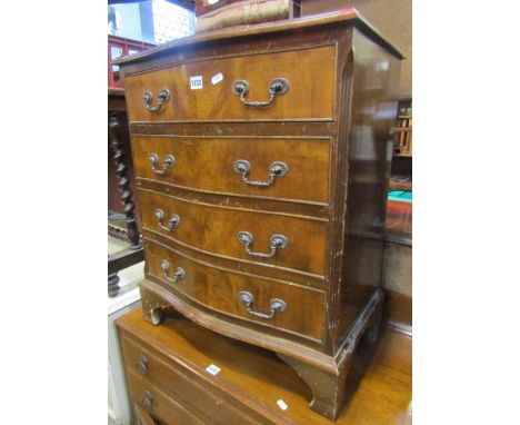 A reproduction Georgian style mahogany veneered bachelors chest, the serpentine front fitted with four long graduated drawers