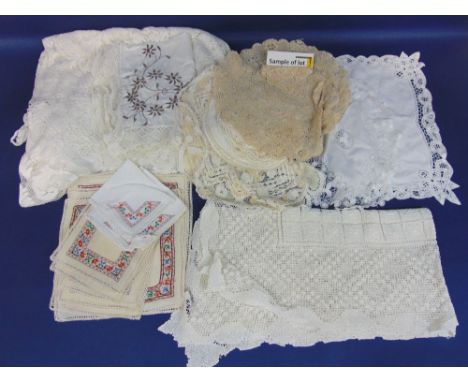 Quantity of vintage table linen, including good  small examples of lacework and pulled threadwork, together with 2 suitcases 