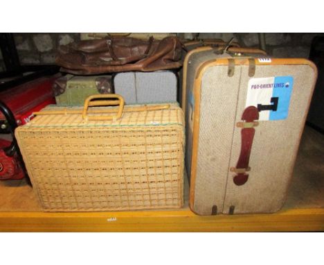 A vintage fibre and timber lathe bound cabin trunk, together with two others, two wicker hampers and a leather holdall