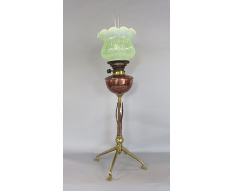 WAS Benson arts and crafts copper and brass oil lamp, with vaseline glass shade, polished brass reservoir upon a brass column
