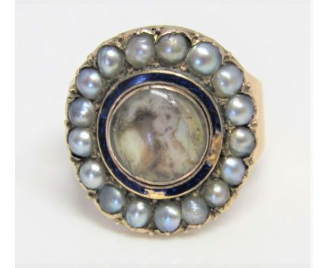 A Georgian gold mourning ring fitted with an Essex crystal portrait, with enamel detail and seed pearl border, inscription to