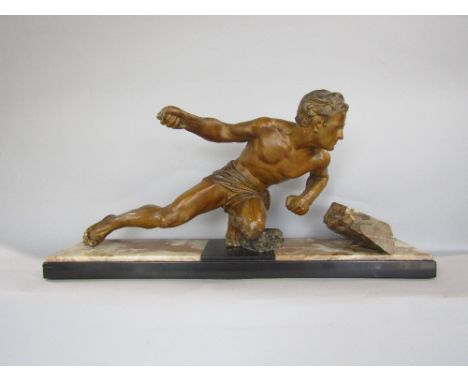Art deco cast spelter figural group of a hunting man wearing a loin cloth, upon a marbled base, 74cm wide