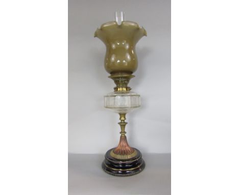 Late 19th century brass and copper oil lamp, with opaline glass shade over a clear faceted glass reservoir and lobed tapered 