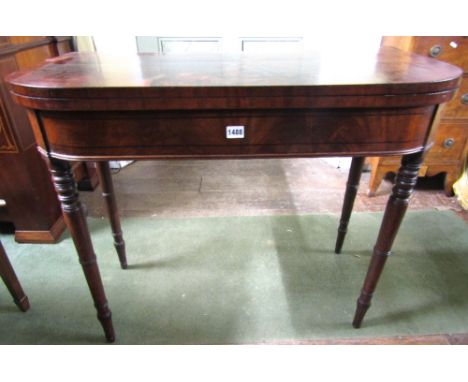 A Regency mahogany D end fold over top card table with ebony string inlay, raised on turned and tapering supports