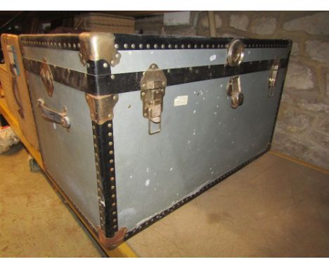 A vintage stained pine trunk with hinged lid and side carrying handles, together with a fibre cabin trunk with stitched leath