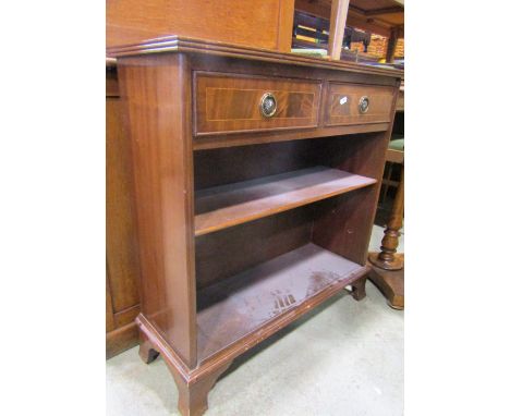 A small reproduction Georgian style walnut veneered chest of four long drawers with serpentine fronts and bracket supports, a