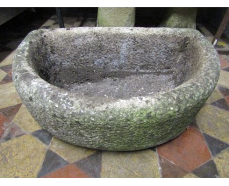 A weathered cast composition stone D shaped garden trough, 64 cm long x 45 cm wide, together with one other (2)