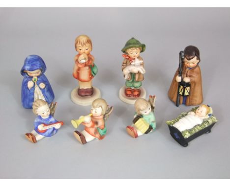 A collection of Goebel Hummel Nativity figures including Mary, Baby Jesus, three angel musicians, a figure with lantern and s