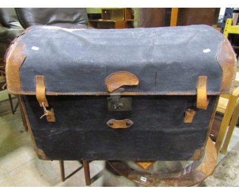 A Victorian wicker and canvas cased travel trunk together with a mahogany mirror