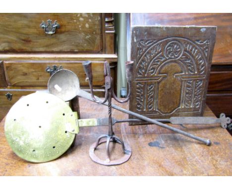 An unusual wrought iron rush nip and double candle stand in wrought iron, raised on a circular base, a Georgian brass and cop