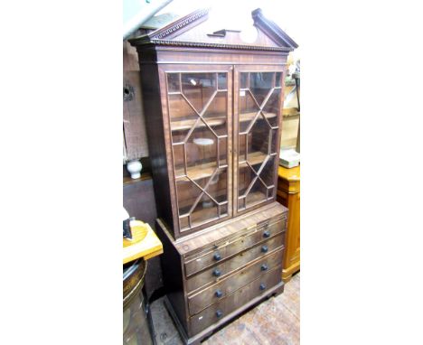 A small Georgian mahogany freestanding cabinet, the lower section enclosed by four long graduated drawers together with a bru