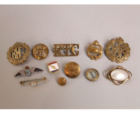 A mixed military lot to include badges, buttons, a small compass and others