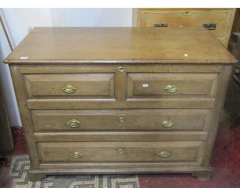 A Georgian oak mule chest with hinged lid and panelled sides, the front elevation enclosed by one real and three dummy fielde