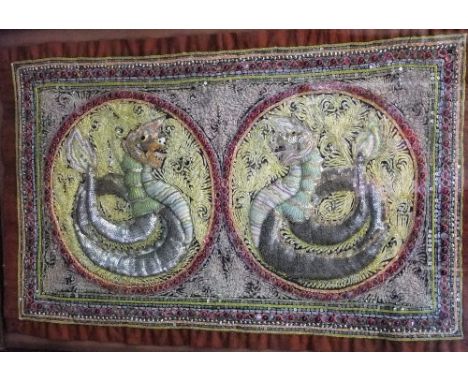 An Eastern embroidered panel with raised coiled dragon decoration incorporating sequins, gilt threadwork, etc, 46 x 77 cm, fr