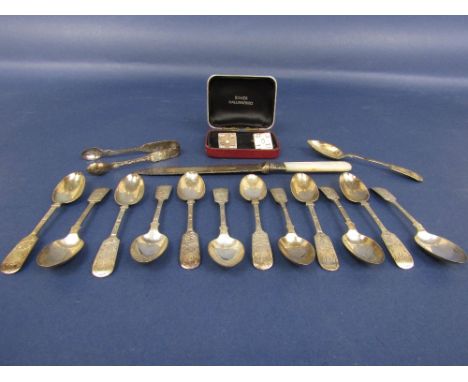 A small quantity of silver flatware to include a collection of fiddle pattern spoons, sugar nips and a pair of silver cuff li