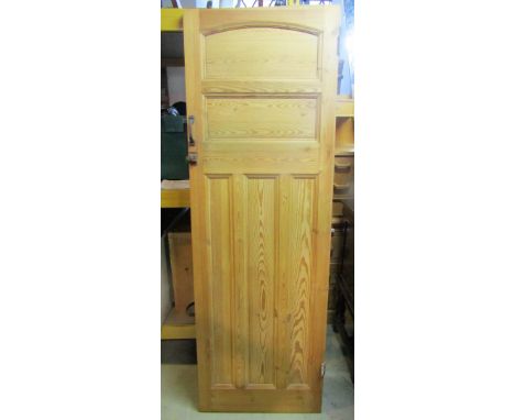 A reclaimed stippled pine interior panelled door, together with a polished brass fender, a further cast iron example and a sm