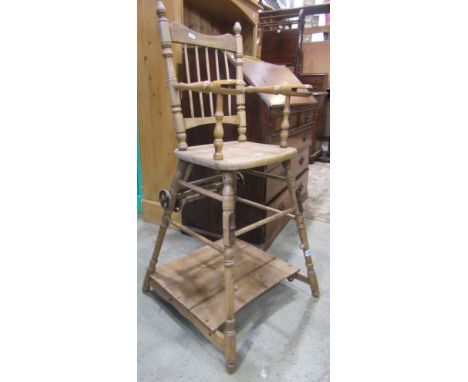 A vintage beechwood metamorphic child's high chair with stick back and turned framework