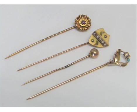 Four gold stick pins to include an art nouveau example set with turquoise, 4g total