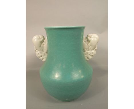 A substantial art deco Poole Pottery vase designed by John Adams with pale green glaze and with two cream glazed handles mode