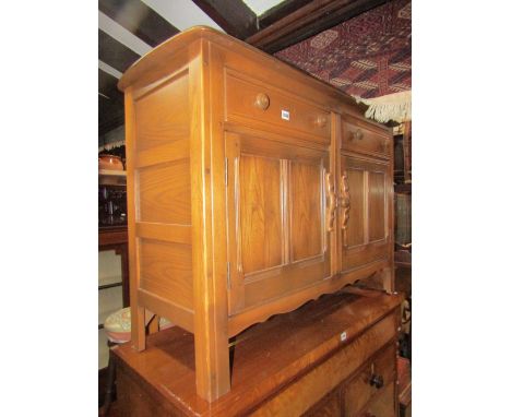 An Ercol Golden Dawn elm dresser base enclosed by two twin panelled moulded doors and two drawers, 4ft wide approx