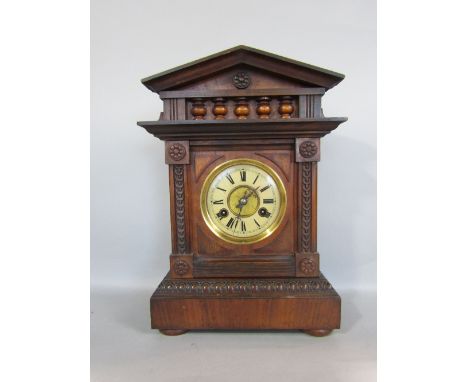 Early 20th century German two train architectural mantle clock, the walnut case enclosing a two train dial with enamel chapte