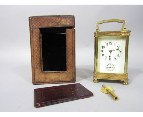 Early 20th century polished brass alarm carriage clock, the enamel face with subsidiary second dial, the case with pierced bo