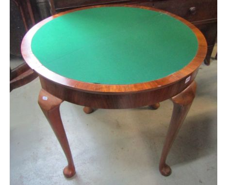 A Georgian style walnut and figured walnut veneered demi-lune fold-over top card table, raised on cabriole supports