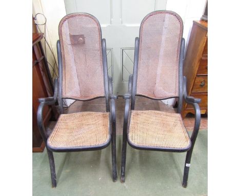 A pair of 19th century bentwood elbow chairs with cane panel seats and backs on swept supports, together with two others (4)