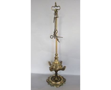 Cast brass chatelaine with snuffer and further candle tools, 60cm high