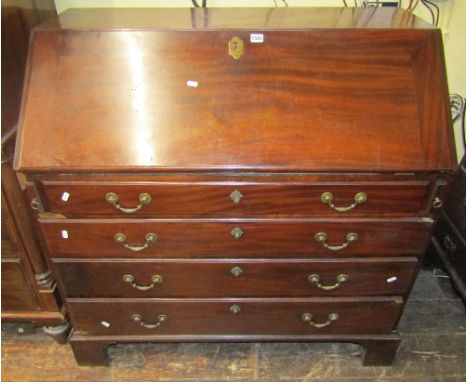 A Georgian mahogany bureau of four long graduated drawers, raised on bracket supports, the fall flap enclosing a simply fitte