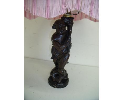 Carved Eastern hardwood table lamp in the form of a standing figure 