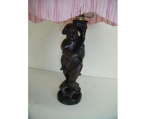 Carved Eastern hardwood table lamp in the form of a standing figure 