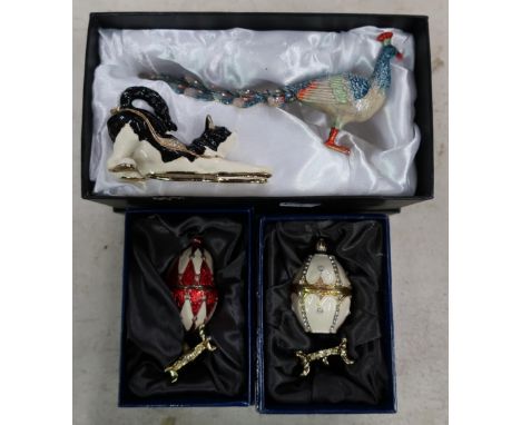 Collection of boxed Treasured Trinket enamel figures including two Russian style eggs, similar figure of a cat and a peacock 