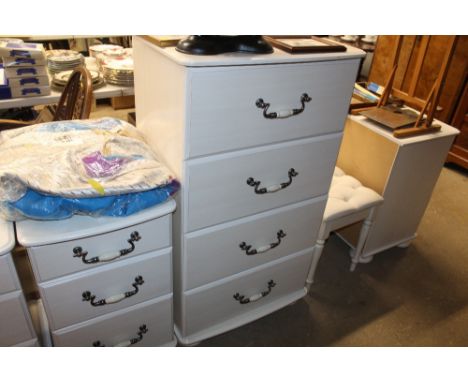 A white laminate chest of four drawers 