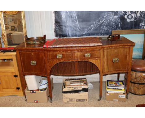 A 19th Century mahogany and cross banded serpentine fronted country house sideboard, having pull out central section enclosed