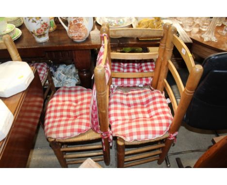 A set of six pine ladder back dining chairs with rush seats