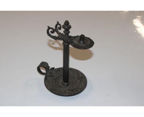 A cast metal wax jack type candlestick 