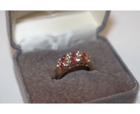 A yellow metal ring, marked 10K set with red and white stones, ring size L, approx. 3gms 